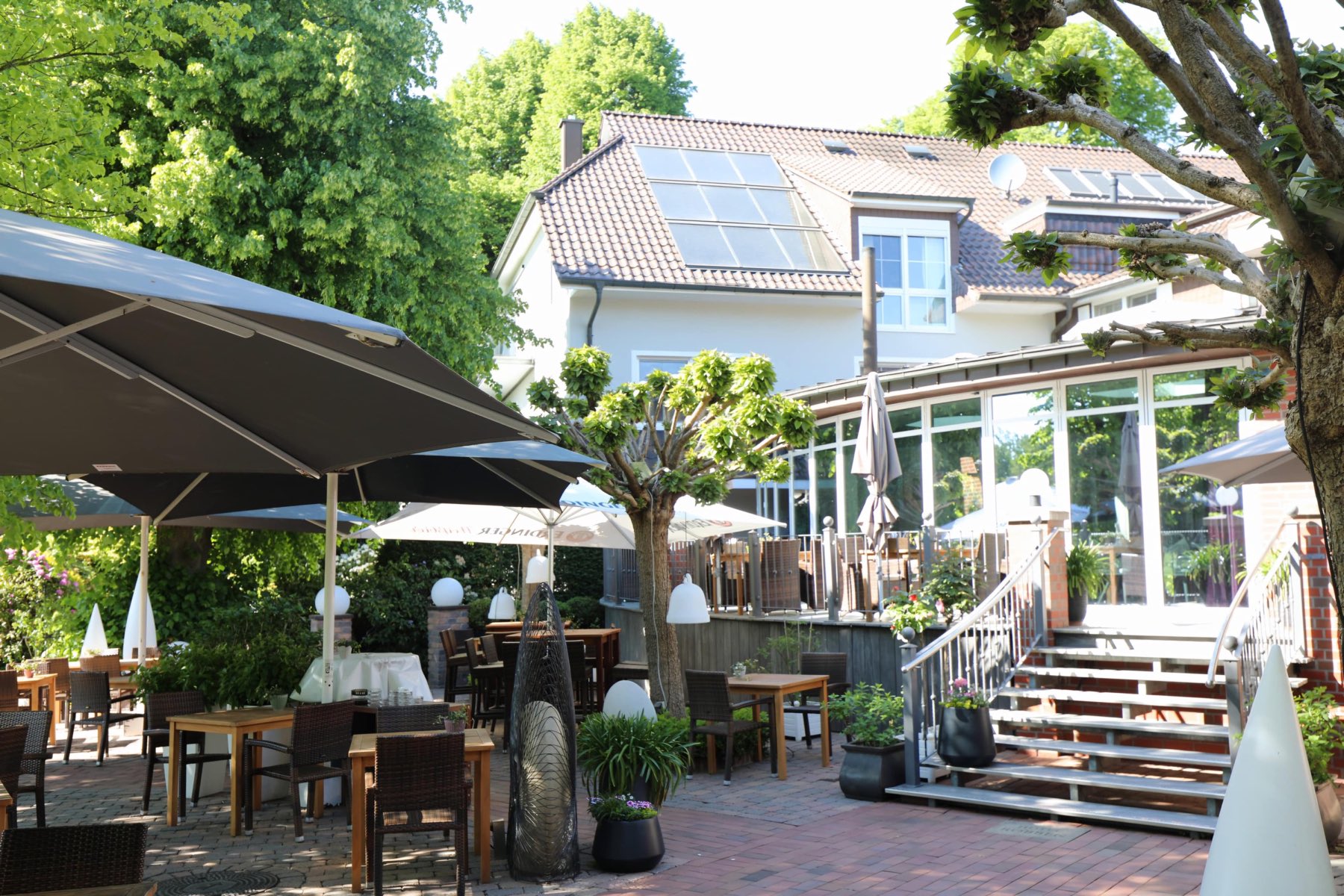 Summer garden of Hotel Robben beneath shady lime trees
